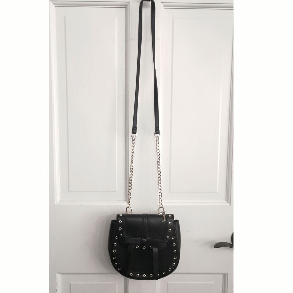 The Express Black Crossbody embellished with Bow metal grommets flap  closure. - Picture 2 of 12